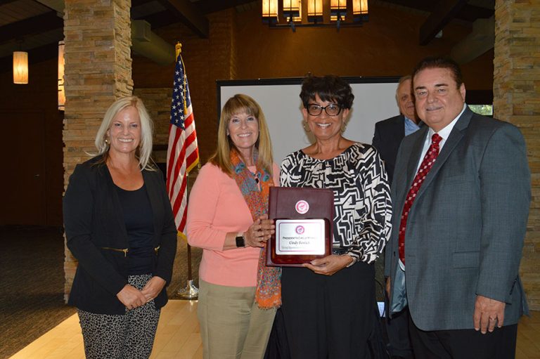 Victor Valley College Foundation supporters presenting a framed President’s Circle award plaque