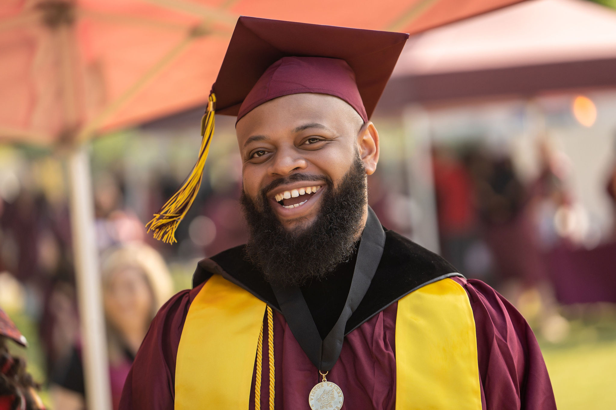 VVC scholarship recipient smiling with a medal at graduation