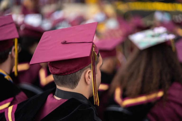 Victor Valley College graduate walking at commencement