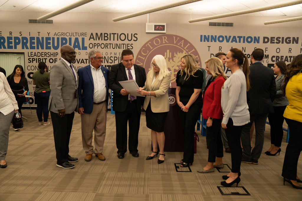 Victor Valley College Foundation leaders reviewing an official document