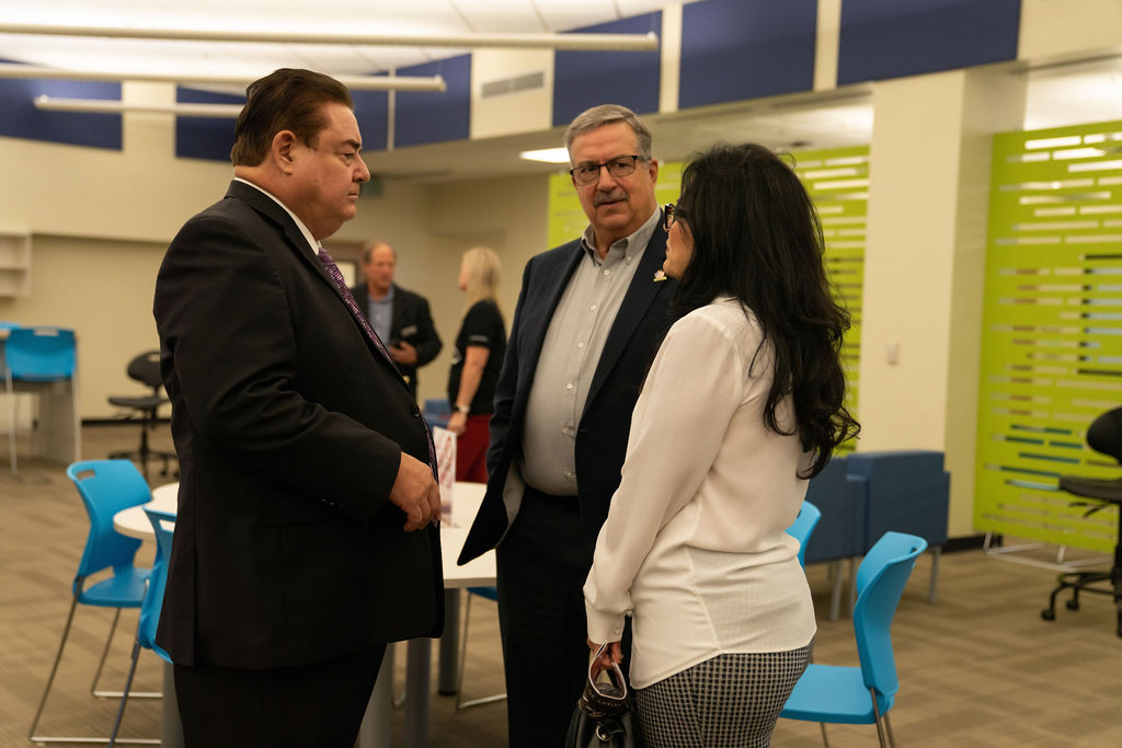 Victor Valley College faculty and staff in conversation at a campus event