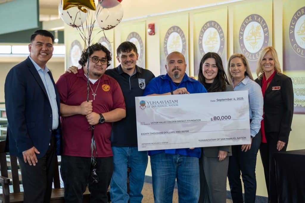 Representatives of Yuhaaviatam of San Manuel Nation and Victor Valley College holding a ceremonial 80,000 dollar cheque made out to the Victor Valley College District Foundation for the Veterans Resource Center