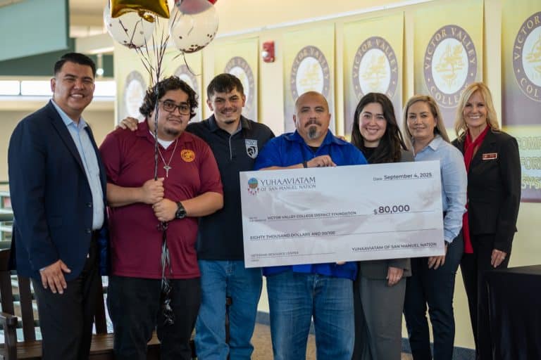 Representatives of Yuhaaviatam of San Manuel Nation and Victor Valley College holding a ceremonial 80,000 dollar cheque made out to the Victor Valley College District Foundation for the Veterans Resource Center