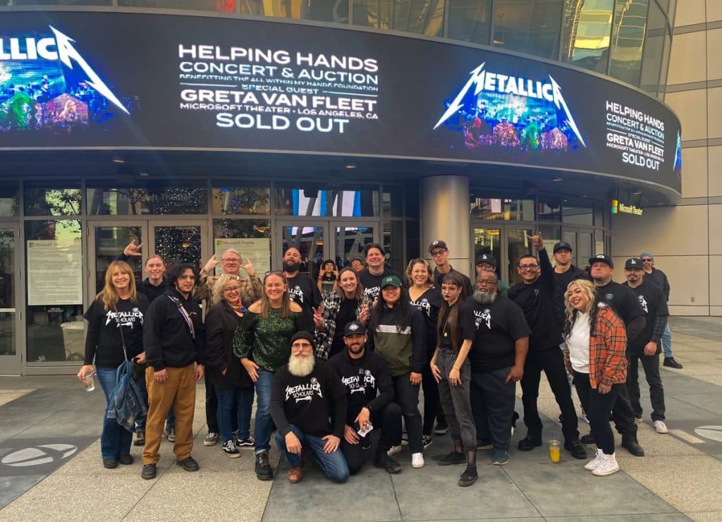 Victor Valley College Metallica Scholars gathered outside the Microsoft Theater in Los Angeles beneath the All Within My Hands Helping Hands Concert and Auction marquee
